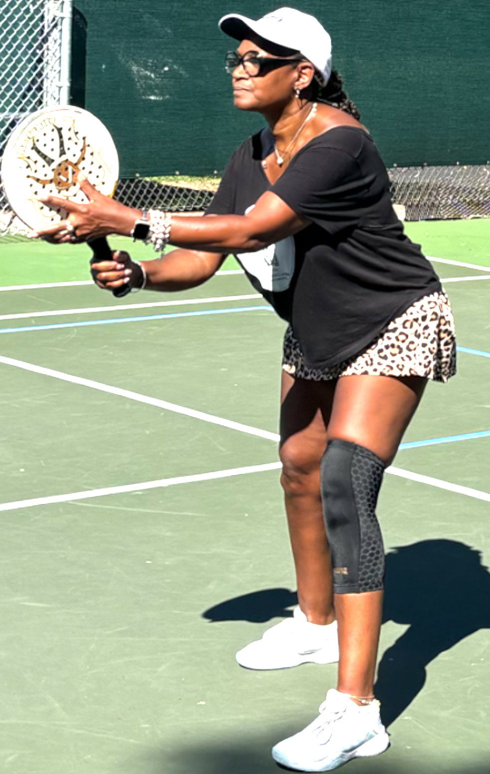 Dr. Allana Coffee playing pickleball outdoors