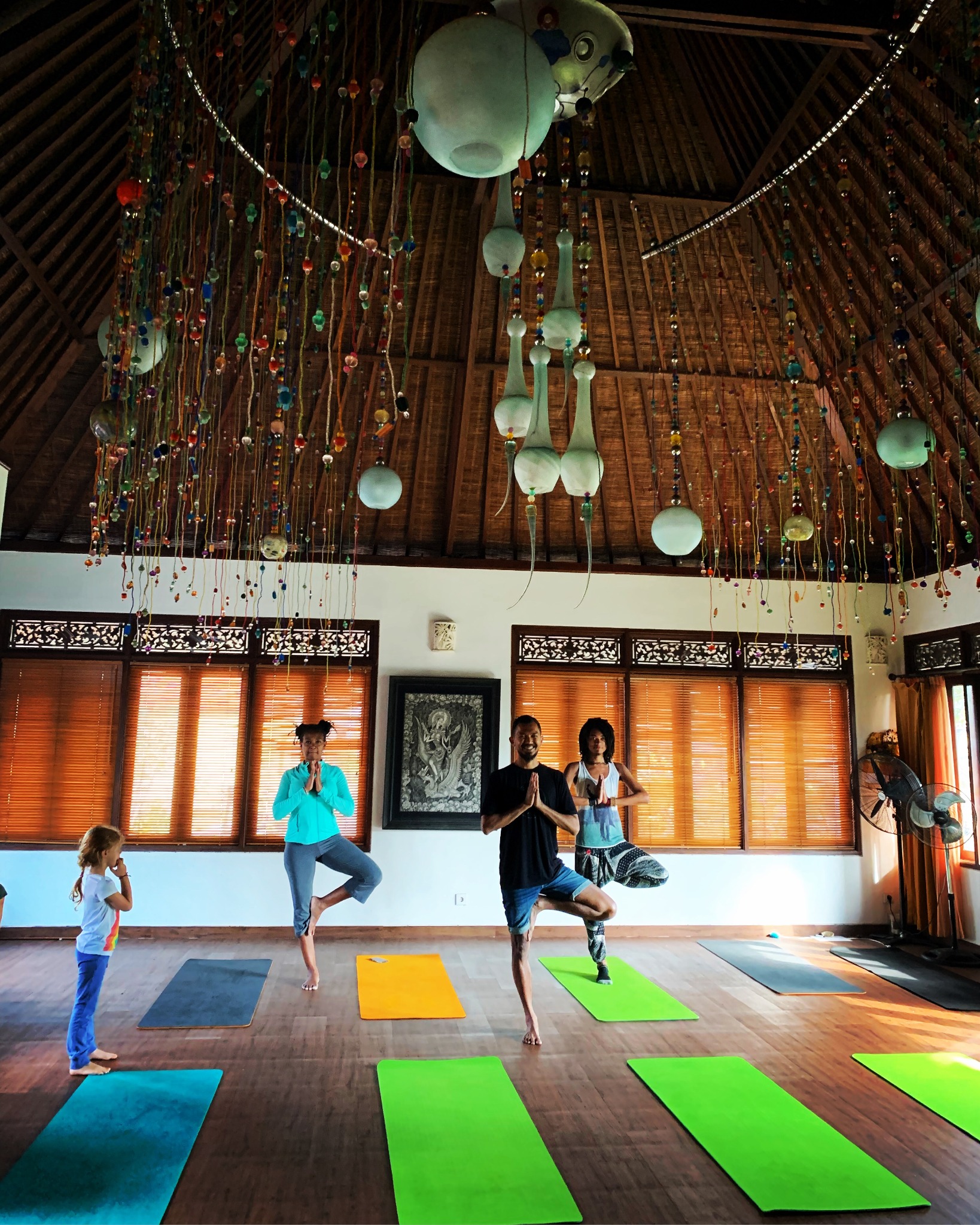 Dr. Coffee and participants practicing yoga together in a bright retreat space
