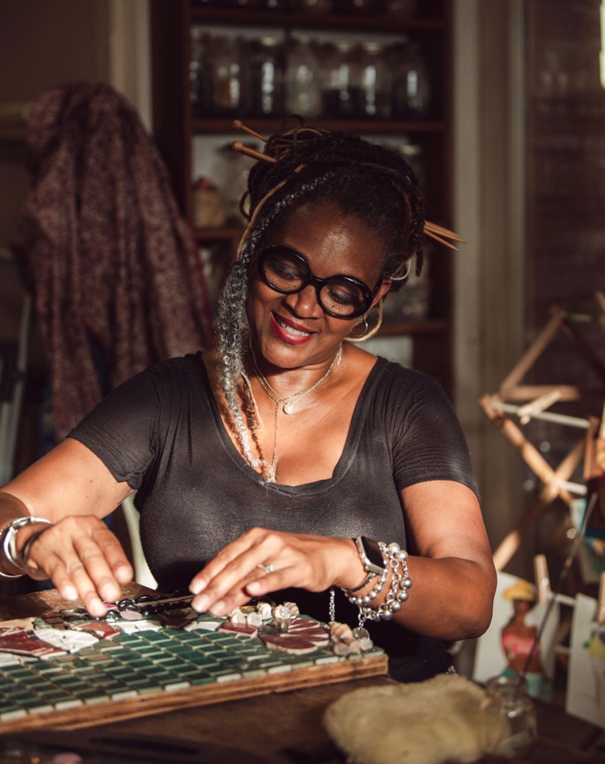 Dr. Allana Coffee creating a mosaic by hand